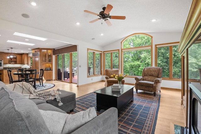 6136 Arctic Way, Edina, MN 55436 - living room with healthy amount of natural light, light wood finished floors, vaulted ceiling, recessed lighting, and a ceiling fan