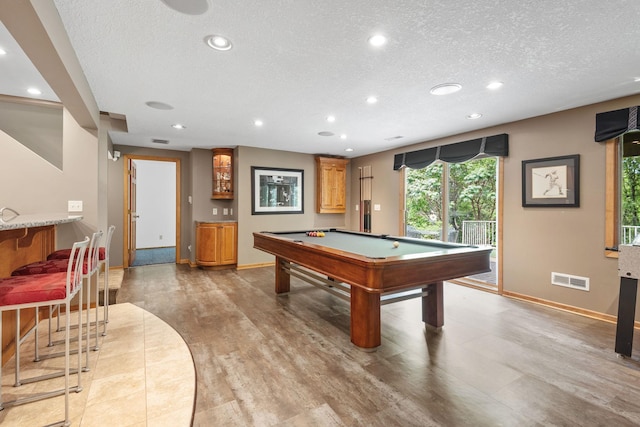 6136 Arctic Way, Edina, MN 55436 - rec room featuring a textured ceiling, recessed lighting, pool table, light wood-style flooring, and bar area