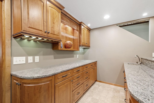 6136 Arctic Way, Edina, MN 55436 - kitchen featuring light stone countertops, brown cabinetry, recessed lighting, and light tile patterned flooring