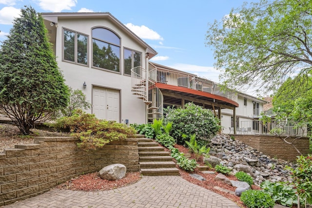 6136 Arctic Way, Edina, MN 55436 - view of front facade with stairway, stucco siding, and a wooden deck
