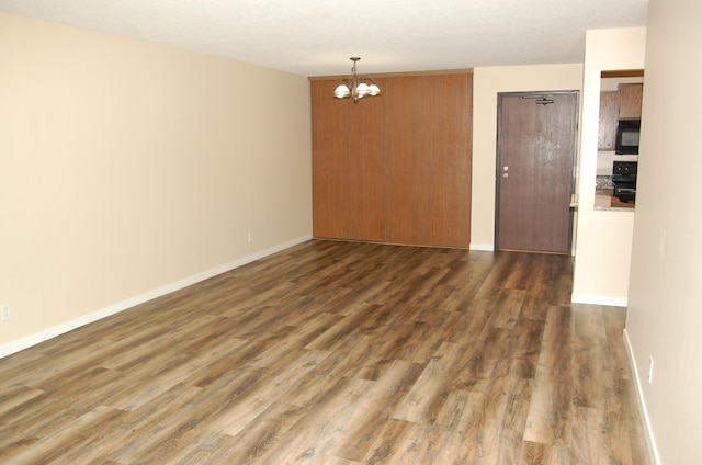 1903 Silver Bell Rd Unit 219, Eagan, MN 55122 - unfurnished room with a chandelier, wood finished floors, and baseboards