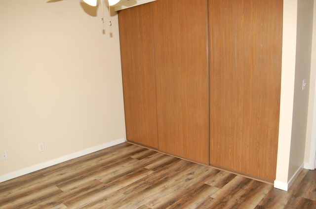 1903 Silver Bell Rd Unit 219, Eagan, MN 55122 - unfurnished bedroom featuring wood finished floors, a closet, a ceiling fan, and baseboards