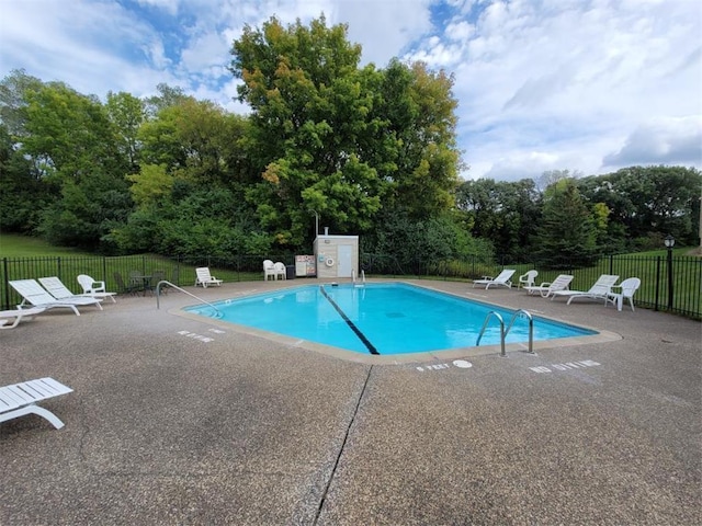 1903 Silver Bell Rd Unit 219, Eagan, MN 55122 - community pool featuring a patio and view of wooded area