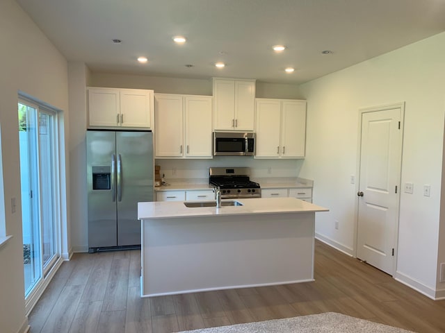 6272 205th St N, Forest Lake, MN 55025 - kitchen with appliances with stainless steel finishes, wood finished floors, white cabinetry, a center island with sink, and recessed lighting