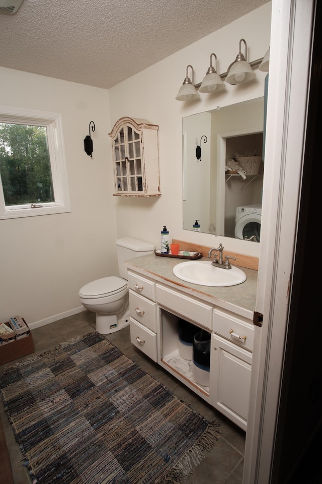 1496 Willard Lake Rd NW, Powers Twp, MN 56435 - bathroom featuring washer / dryer, tile patterned flooring, vanity, and a textured ceiling