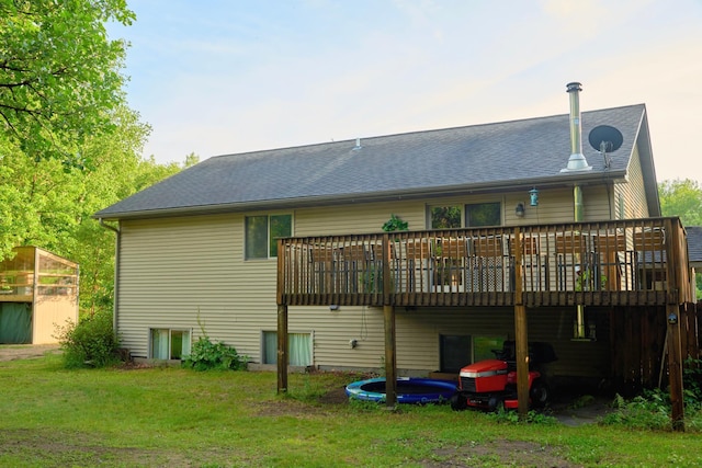 1496 Willard Lake Rd NW, Powers Twp, MN 56435 - rear view of house with a wooden deck, a lawn, and roof with shingles
