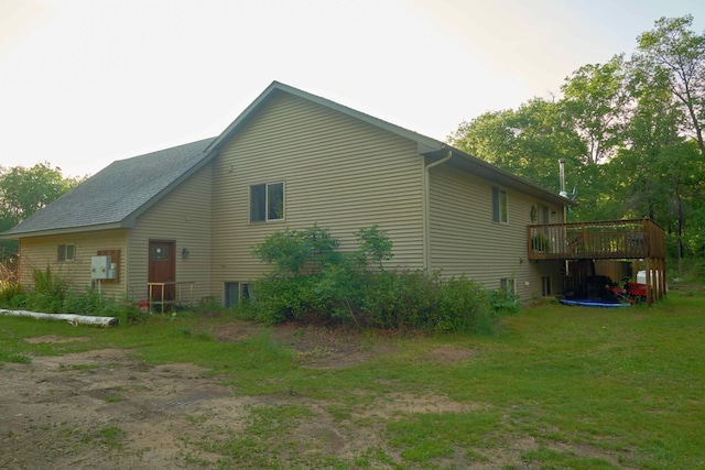 1496 Willard Lake Rd NW, Powers Twp, MN 56435 - view of side of home with a wooden deck and a yard