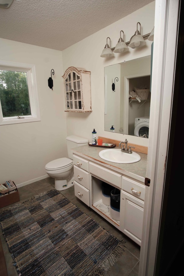 1496 Willard Lake Rd NW, Powers Twp, MN 56435 - bathroom featuring washer / clothes dryer, tile patterned floors, vanity, and a textured ceiling