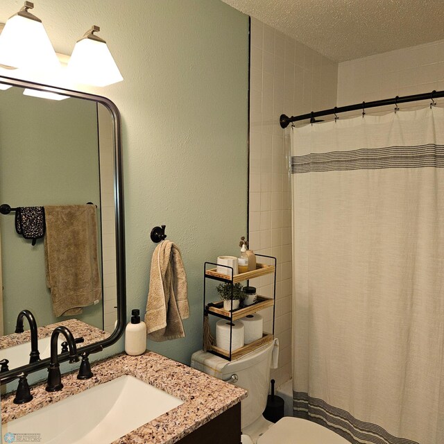 849 11th Ave W, West Fargo, ND 58078 - bathroom featuring vanity, toilet, shower / bath combo with shower curtain, and a textured ceiling