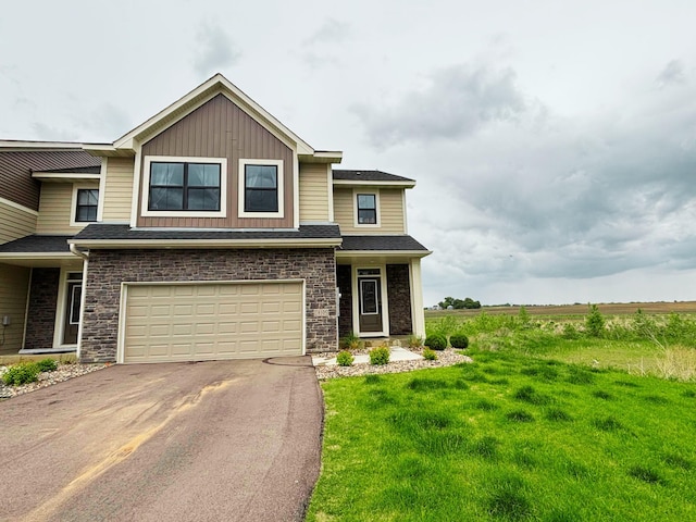 18105 Gavel Ln, Lakeville, MN 55044 - view of front of home featuring asphalt driveway, a garage, a front yard, board and batten siding, and roof with shingles