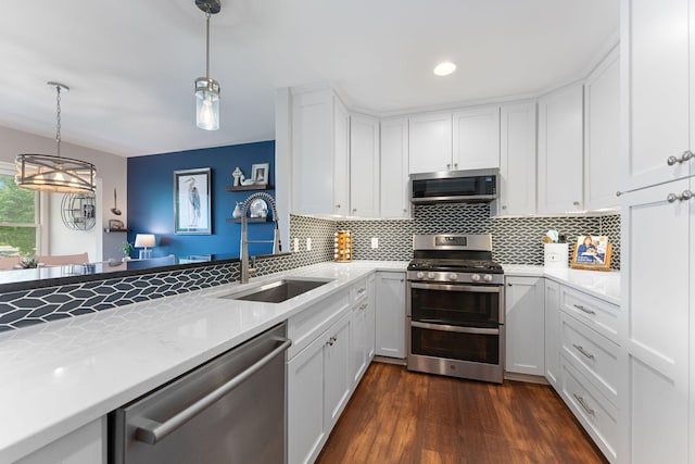 6813 Boudin St NE, Prior Lake, MN 55372 - kitchen with stainless steel appliances, decorative backsplash, white cabinets, pendant lighting, and recessed lighting