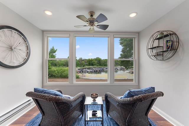 6813 Boudin St NE, Prior Lake, MN 55372 - living area featuring baseboard heating, wood finished floors, a ceiling fan, healthy amount of natural light, and recessed lighting