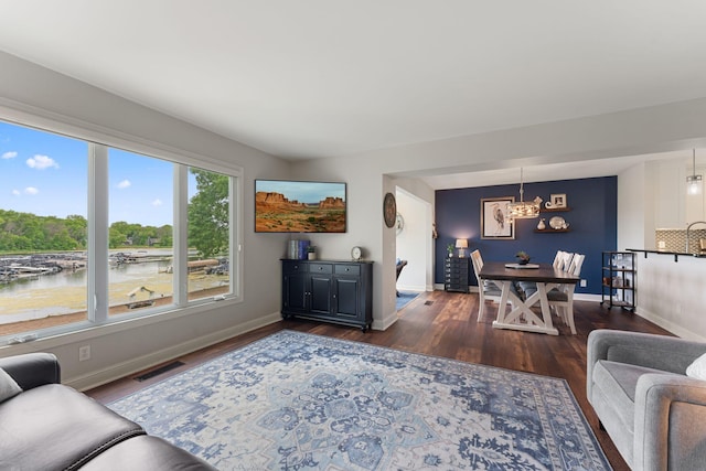 6813 Boudin St NE, Prior Lake, MN 55372 - living area with dark wood-style floors, a chandelier, and a water view