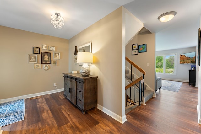 6813 Boudin St NE, Prior Lake, MN 55372 - corridor with dark wood-type flooring, stairs, and a chandelier