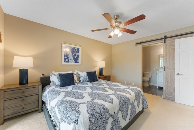 6813 Boudin St NE, Prior Lake, MN 55372 - carpeted bedroom featuring a barn door, a ceiling fan, and connected bathroom