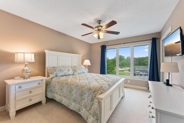 6813 Boudin St NE, Prior Lake, MN 55372 - bedroom featuring light colored carpet, a textured ceiling, and a ceiling fan