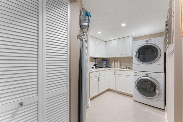 6813 Boudin St NE, Prior Lake, MN 55372 - laundry room with stacked washing machine and dryer, a textured ceiling, light tile patterned floors, and recessed lighting