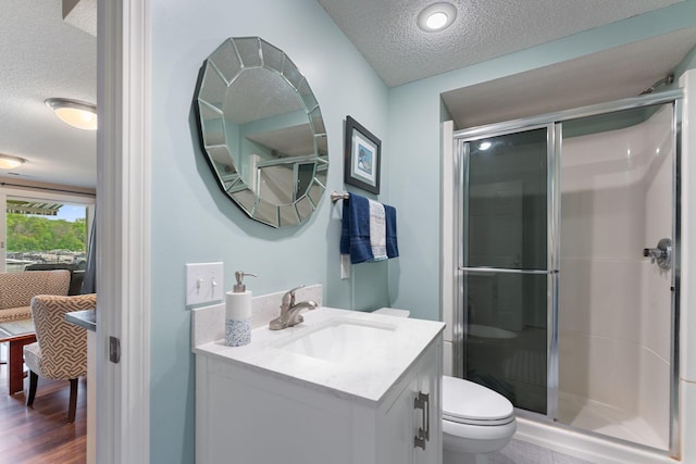 6813 Boudin St NE, Prior Lake, MN 55372 - full bathroom with a textured ceiling, vanity, a shower stall, and wood finished floors