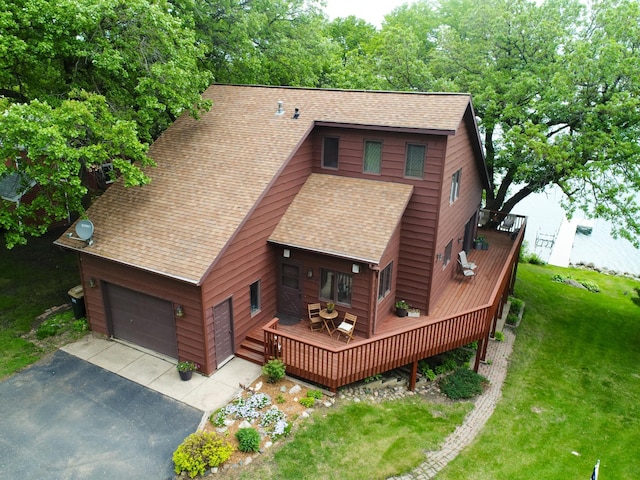 21534 275th Ave, Glenwood Twp, MN 56381 - view of front of house featuring roof with shingles, a wooden deck, a garage, driveway, and a front lawn