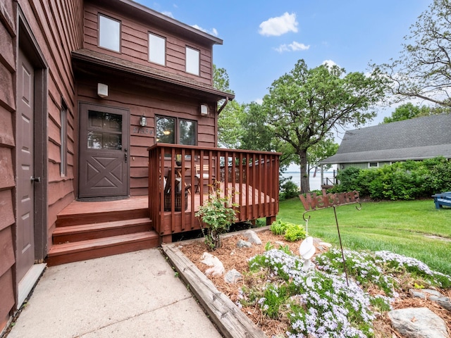 21534 275th Ave, Glenwood Twp, MN 56381 - doorway to property featuring a lawn and a wooden deck