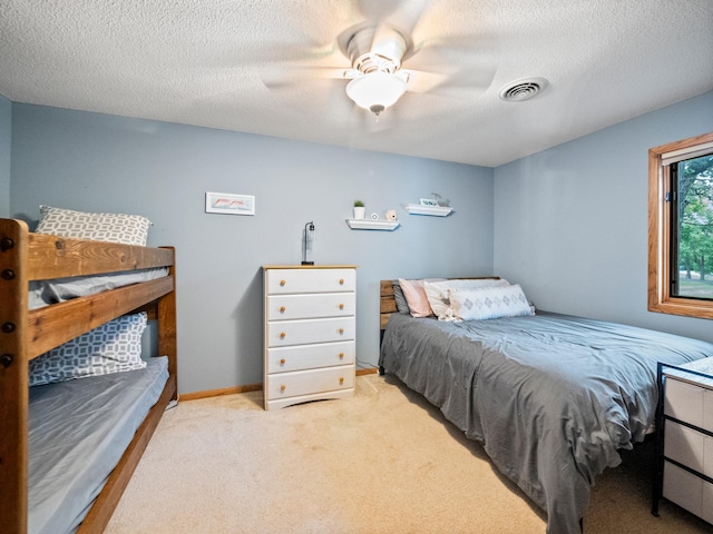 21534 275th Ave, Glenwood Twp, MN 56381 - bedroom featuring a textured ceiling, a ceiling fan, light colored carpet, and baseboards