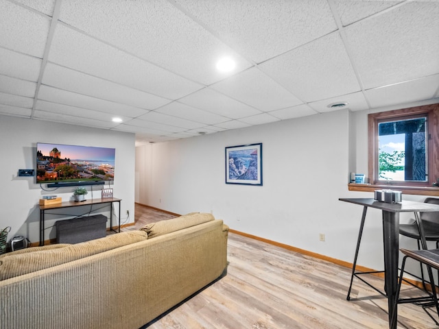 21534 275th Ave, Glenwood Twp, MN 56381 - living room with wood finished floors, a paneled ceiling, and baseboards