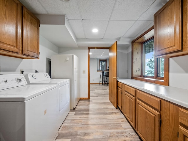 21534 275th Ave, Glenwood Twp, MN 56381 - laundry room with washing machine and clothes dryer, light wood finished floors, cabinet space, baseboards, and recessed lighting