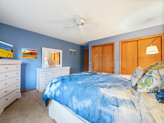 21534 275th Ave, Glenwood Twp, MN 56381 - bedroom with light colored carpet, multiple closets, a ceiling fan, and baseboards