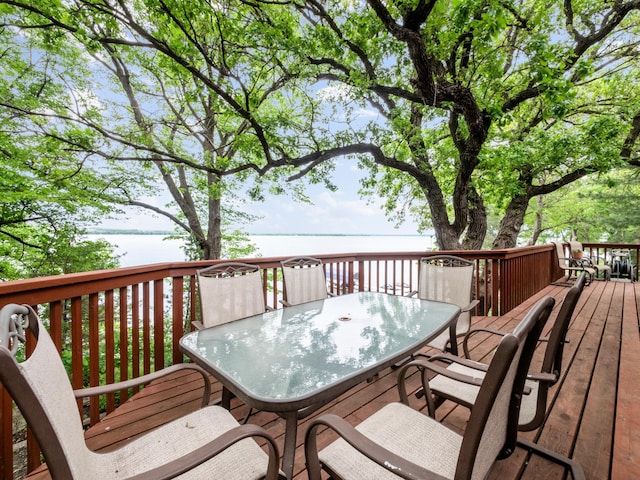21534 275th Ave, Glenwood Twp, MN 56381 - wooden deck with outdoor dining space and a water view
