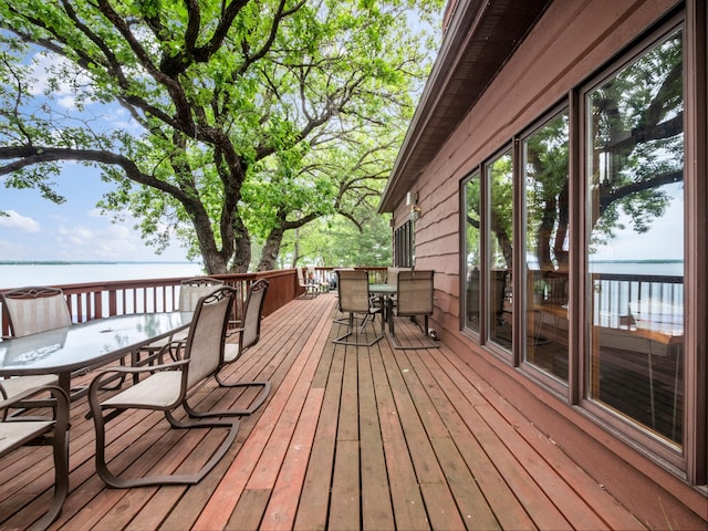 21534 275th Ave, Glenwood Twp, MN 56381 - wooden terrace featuring outdoor dining area and a water view