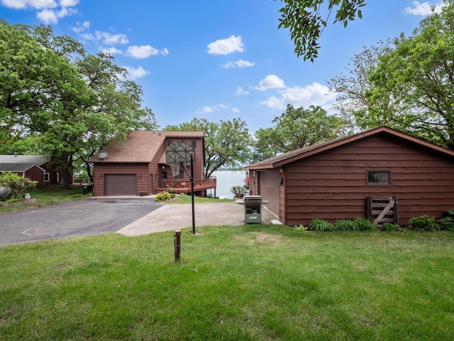 21534 275th Ave, Glenwood Twp, MN 56381 - view of property exterior featuring asphalt driveway, a garage, a yard, and a wooden deck