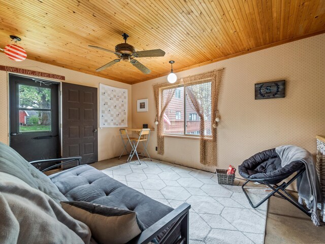 21534 275th Ave, Glenwood Twp, MN 56381 - living area featuring wood ceiling, ceiling fan, lofted ceiling, wallpapered walls, and ornamental molding