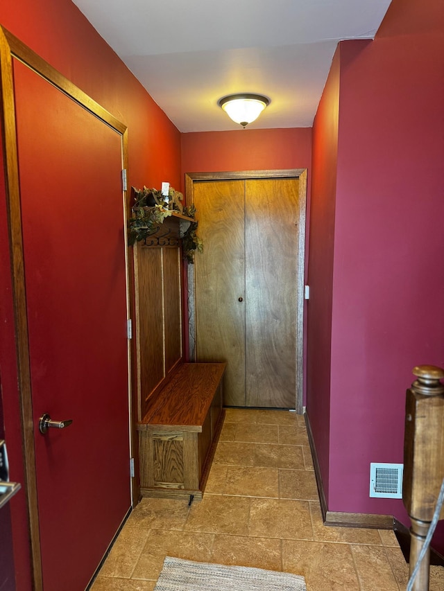 802 Estates Ave, Litchfield, MN 55355 - mudroom featuring baseboards and light stone finish flooring