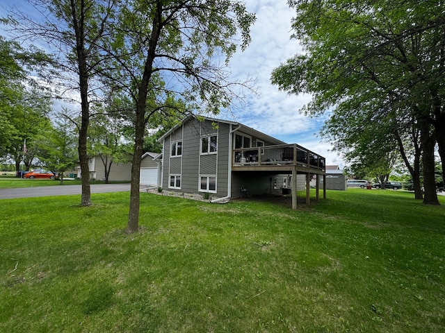 802 Estates Ave, Litchfield, MN 55355 - view of property exterior featuring a deck, a yard, and asphalt driveway