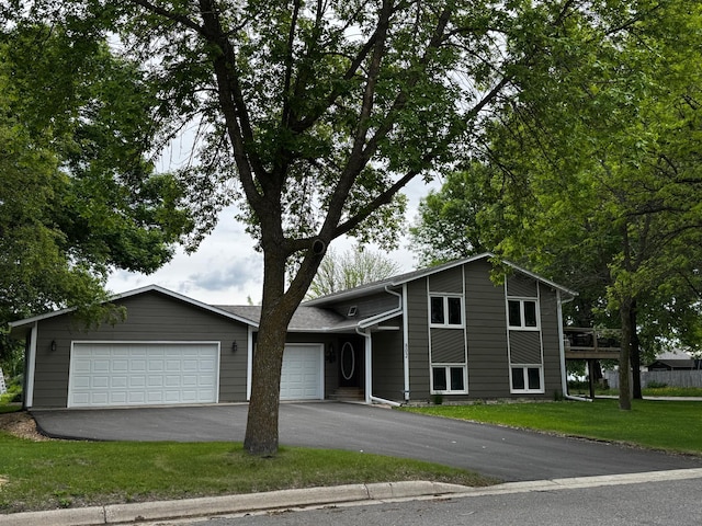 802 Estates Ave, Litchfield, MN 55355 - view of front facade featuring a garage, asphalt driveway, and a front lawn