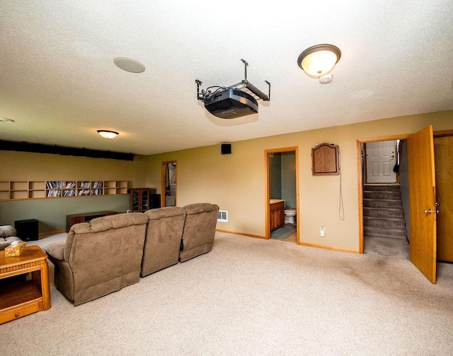 2030 Joes Lake Rd SE, Cambridge, MN 55008 - carpeted living area with stairs and a textured ceiling