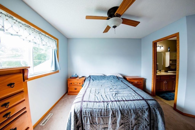 2030 Joes Lake Rd SE, Cambridge, MN 55008 - carpeted bedroom featuring connected bathroom, a ceiling fan, and a textured ceiling