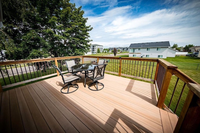 2030 Joes Lake Rd SE, Cambridge, MN 55008 - wooden deck featuring outdoor dining space and a lawn