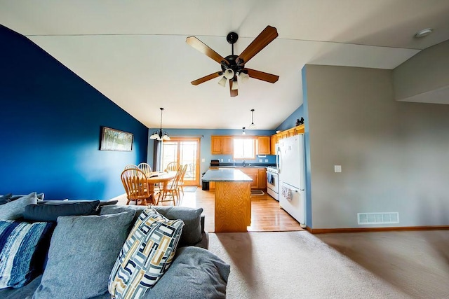 2030 Joes Lake Rd SE, Cambridge, MN 55008 - living area with vaulted ceiling, a ceiling fan, and light carpet