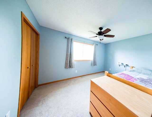 2030 Joes Lake Rd SE, Cambridge, MN 55008 - unfurnished bedroom with light carpet, a closet, a textured ceiling, and a ceiling fan