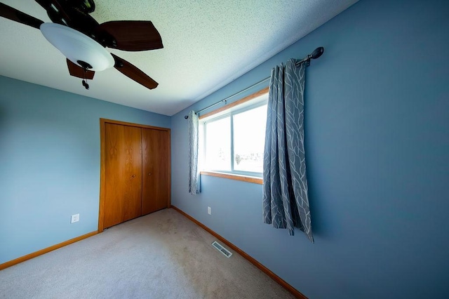 2030 Joes Lake Rd SE, Cambridge, MN 55008 - unfurnished bedroom with a closet, carpet floors, and ceiling fan