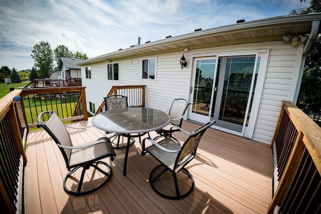 2030 Joes Lake Rd SE, Cambridge, MN 55008 - wooden deck with outdoor dining area and a yard