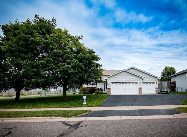 2030 Joes Lake Rd SE, Cambridge, MN 55008 - view of front facade with an attached garage, driveway, and stone siding