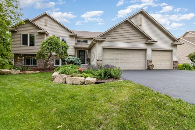 26821 Weston Ct, Elko New Market, MN 55020 - view of front of home with driveway, an attached garage, a front yard, and brick siding