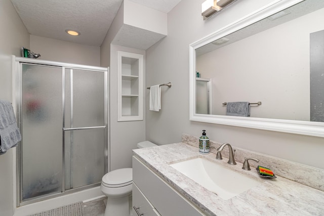 26821 Weston Ct, Elko New Market, MN 55020 - bathroom featuring vanity, toilet, a stall shower, a textured ceiling, and tile patterned floors