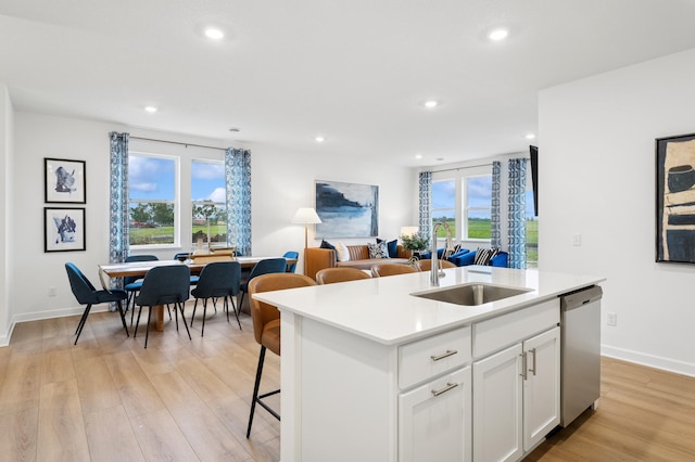 2451 Jandell Ave NE, Saint Michael, MN 55376 - kitchen with stainless steel dishwasher, light wood finished floors, healthy amount of natural light, a center island with sink, and recessed lighting
