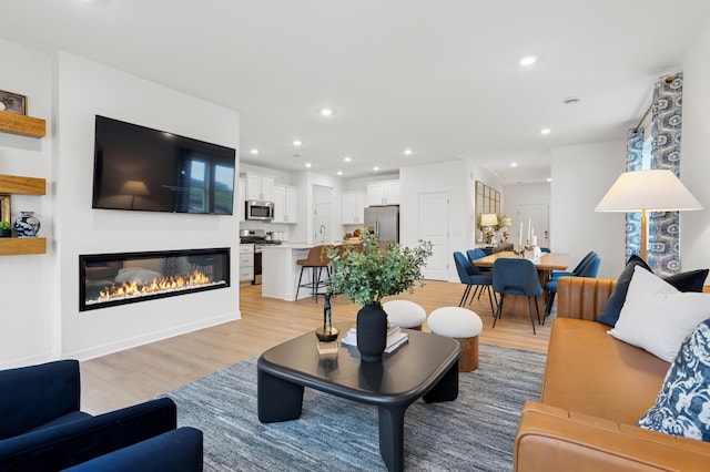 2451 Jandell Ave NE, Saint Michael, MN 55376 - living area featuring a glass covered fireplace, light wood-style flooring, and recessed lighting