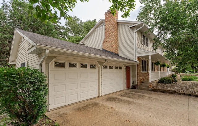 805 5th St NW, Kasson, MN 55944 - view of side of property featuring a chimney, an attached garage, concrete driveway, and brick siding