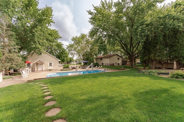 805 5th St NW, Kasson, MN 55944 - view of green lawn featuring an outdoor pool and a patio area