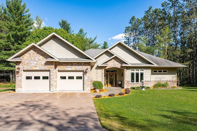 79394 Long Lake Rd, Kettle River Twp, MN 55795 - craftsman-style home with stone siding, concrete driveway, a front yard, and an attached garage